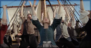 This is a banner for a review of The Testament of Ann Lee. Image courtesy of the filmmakers and Searchlight Pictures.